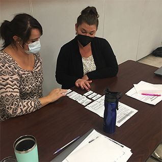 Teachers looking at nametags on desk