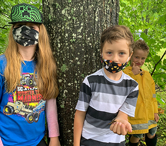 Two elementary students in the woods